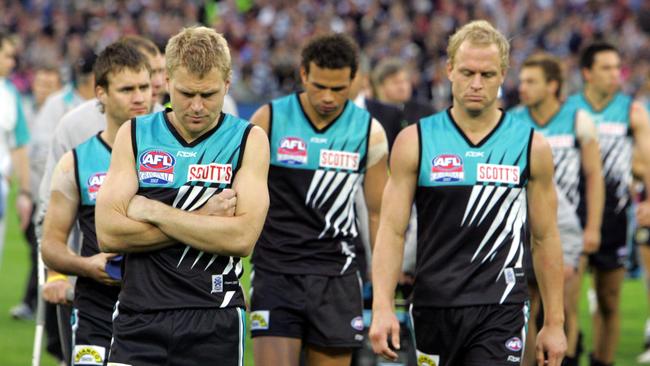 Kane Cornes, Daniel Motlop and Chad Cornes after its thrashing from Geelong in the 2007 grand final.