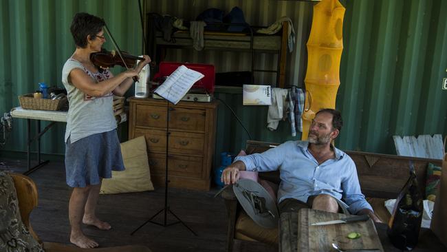 John Van Der Kellen and Jane Morgan in the basic structure they live in while visiting their property outside Nimbin. Picture: Andrew Quilty