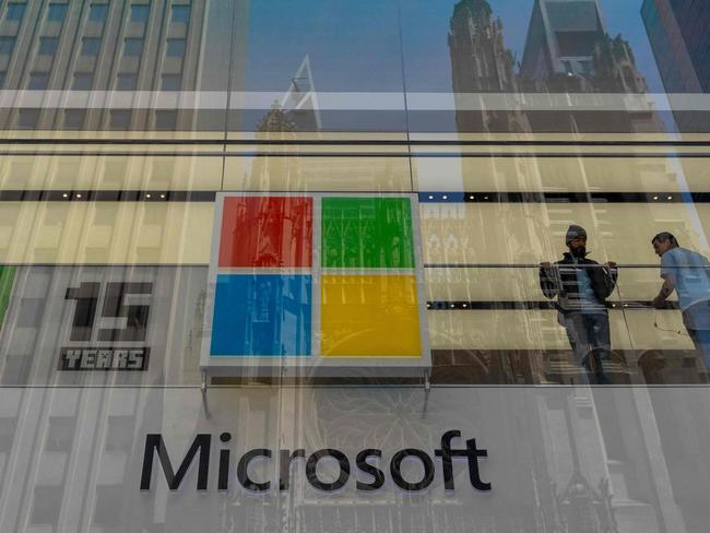 NEW YORK, NEW YORK - JULY 19: People stand inside the Microsoft store on Fifth Avenue on July 19, 2024 in New York City. Businesses and transport worldwide were affected by a global technology outage that was attributed to a software update issued by CrowdStrike, a cybersecurity firm whose software is used by many industries around the world.   Adam Gray/Getty Images/AFP (Photo by Adam Gray / GETTY IMAGES NORTH AMERICA / Getty Images via AFP)