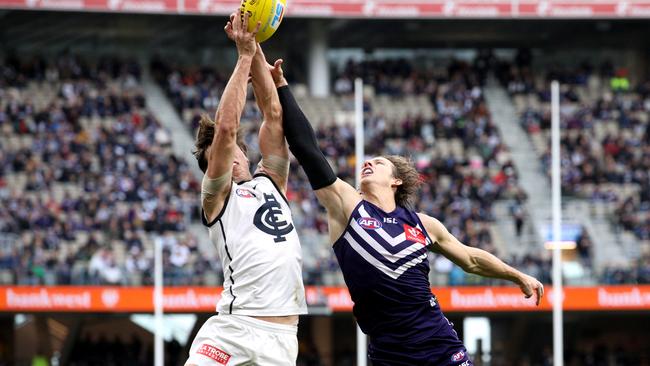 Nat Fyfe attempts to spoil Caleb Marchbank. Picture: AAP