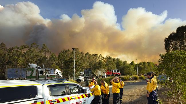 Smoke billows over a closed road in Taree.