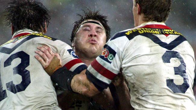  Most physical game ... typical Martin Lang run in the 2003 grand final as he is hit by Luke Ricketson and Ryan Cross. Picture: Brett Faulkner 