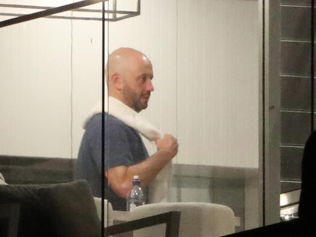 Greenberg with a white towel as he cooks at home after being stood down on Monday. Picture: Jonathan Ng