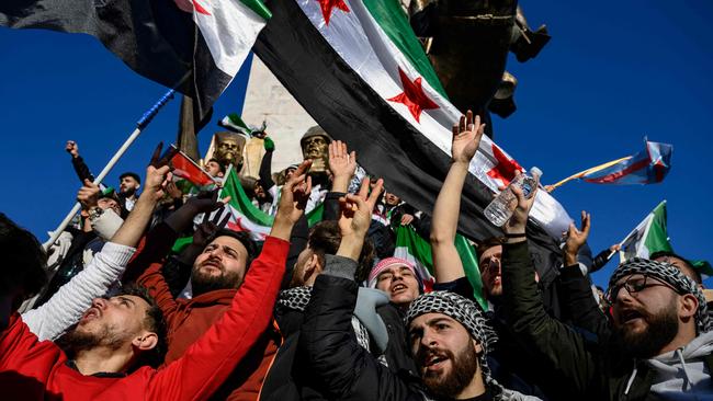 Syrian residents in Turkey wave Syrian opposition flags as they celebrate the fall of long-time ruler Bashar al-Assad. Picture: AFP