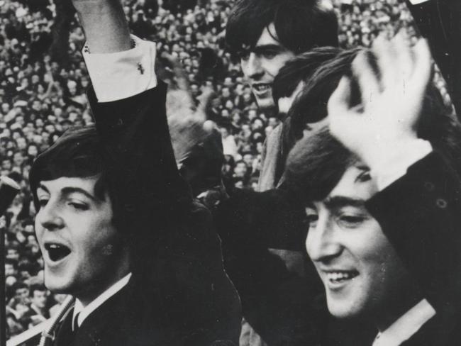 The Australian 50th - 1964. The Beatles wave to unprecedented crowds outside the Southern Cross Hotel, Melbourne. HWT ARCHIVAL NEGATIVE. Picture: Supplied