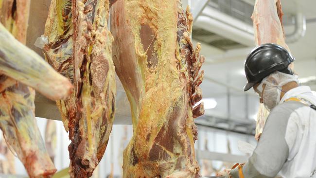 A worker at the JBS Meatworks and abattoir at Dinmore.