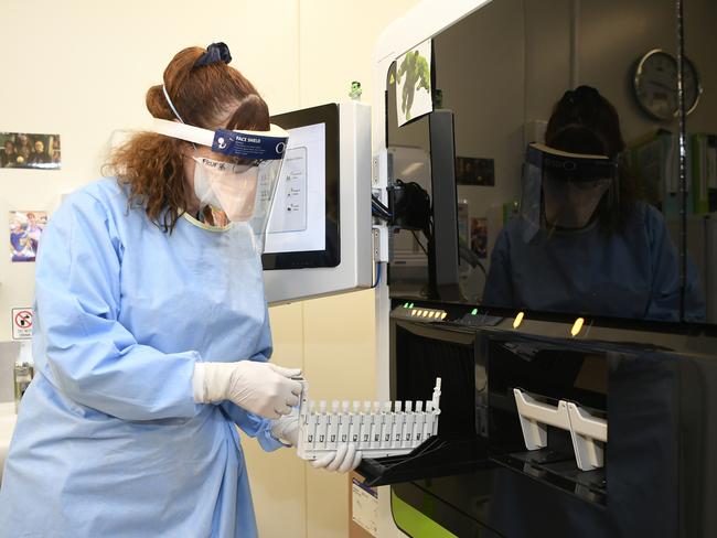 Pathology Queensland supervising scientist Fleur Francis loads the analyser.