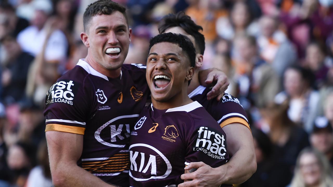 Corey Oates celebrates scoring a try with his Broncos teammates. Picture: Albert Perez/Getty Images