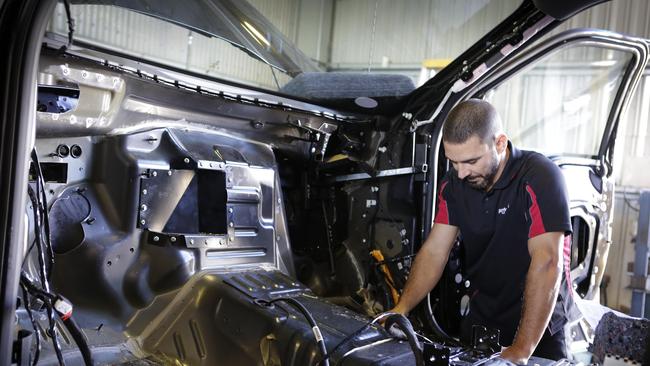 Maikol Giraldes working on a car for Performax. Picture: AAP/Megan Slade