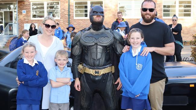 Finn O'Donovan and Batman with parents Rebecca and Ross and siblings Nia and Ella at Panania Public School.