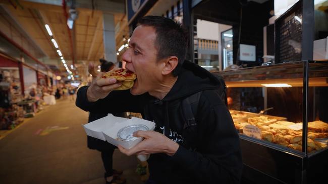 Wien took the biggest bite as he tried the meat pie for the first time. Picture: Mark Wiens / YouTube