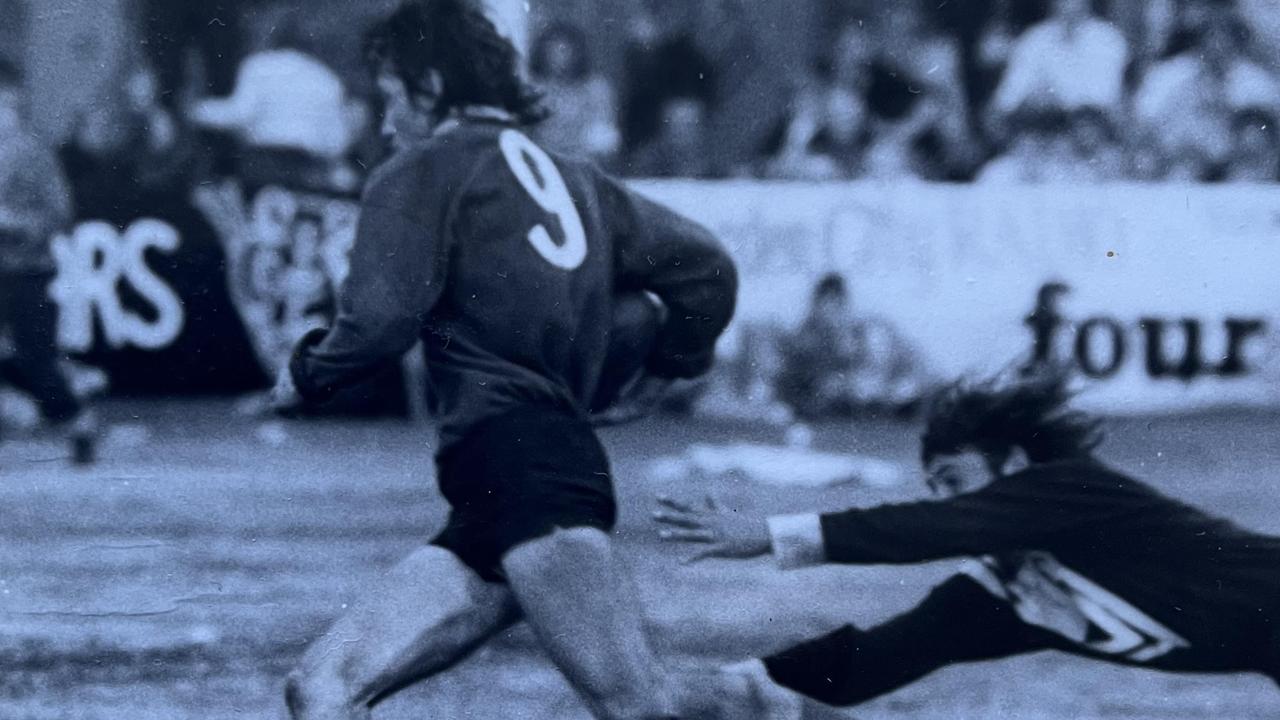 Newtown Lions second rower Graeme Wockner sprints to the try line in the 1973 TRL grand final as Oakey Bears fullback Mal Muirhead tries to stop him.