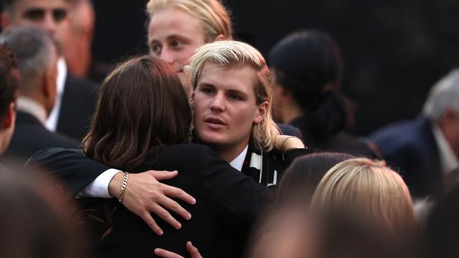 Jackson Warne hugs family and friends during the state memorial service. Picture: Getty Images