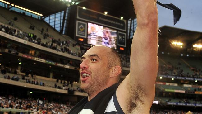 An injured James Podsiadly celebrates Geelong’s 2011 Grand Final triumph.