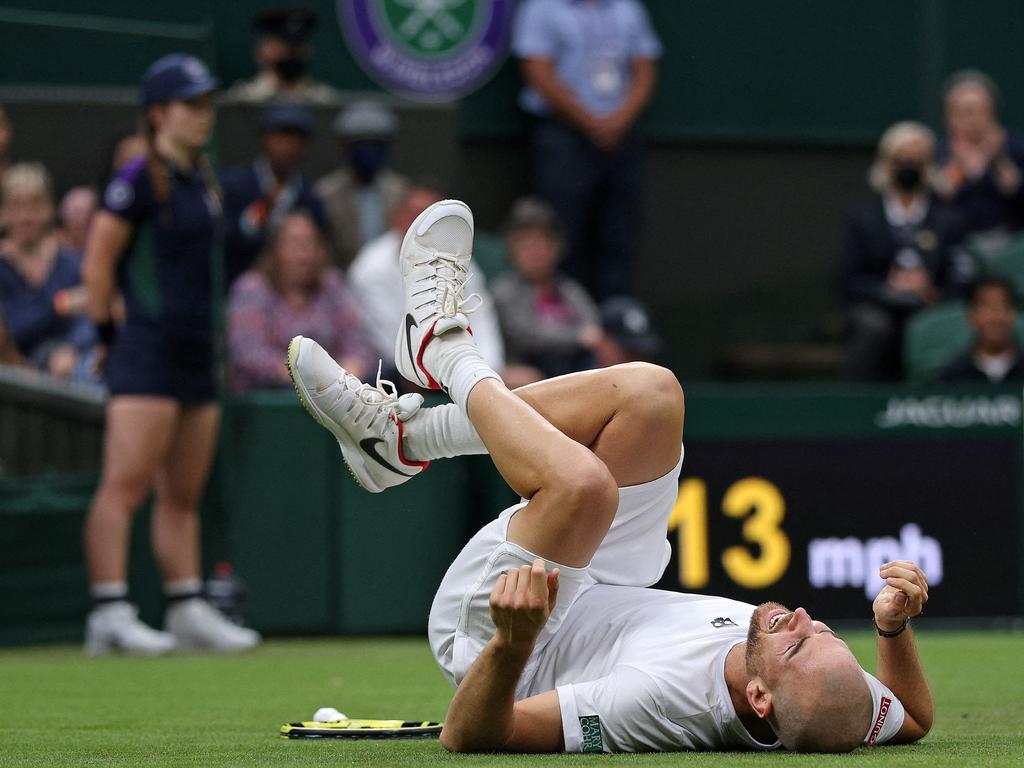 France's Adrian Mannarino reacts after slipping on the grass.