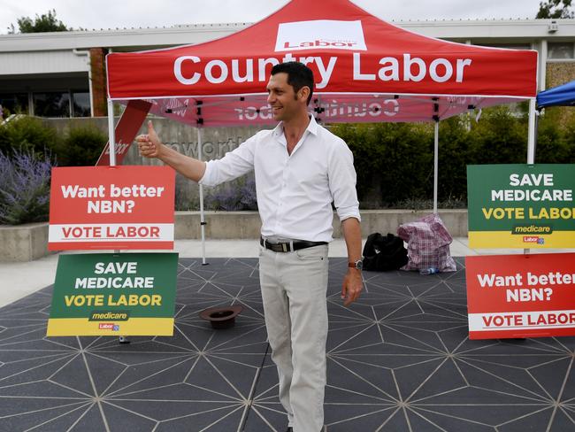 Labor candidate David Ewings hands out cards at Tamworth High School.