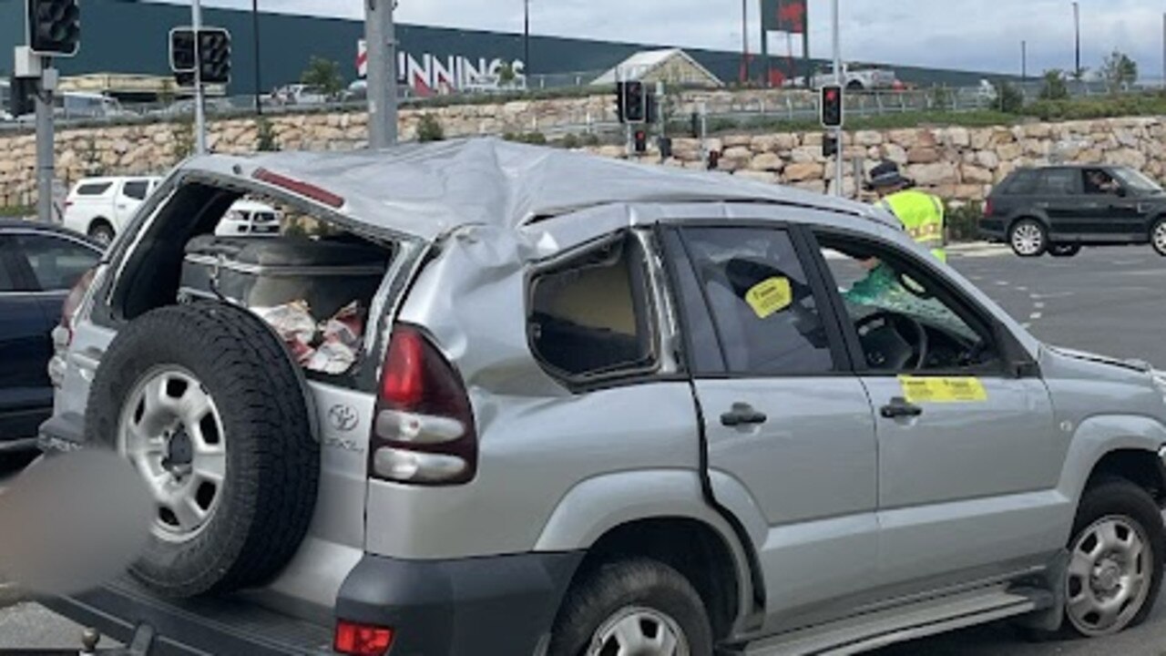 A car flipped in a two-vehicle crash at a busy intersection outside Kawungan Bunnings on Sunday, November 26, 2023. Picture: Adam Miller