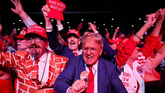 Trump supporters react as his campaign declares victory during an election night event at the Palm Beach Convention Centre. Picture: Getty Images via AFP.