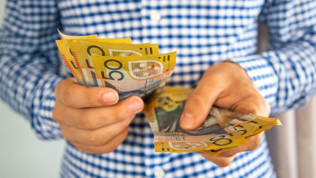 Man handling fifty dollar notes finance. Money and bills economy  Picture: istock