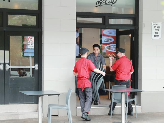 McDonalds workers at Circular Quay pack away tables as cafes ban patrons from eating on the premises Picture: John Feder