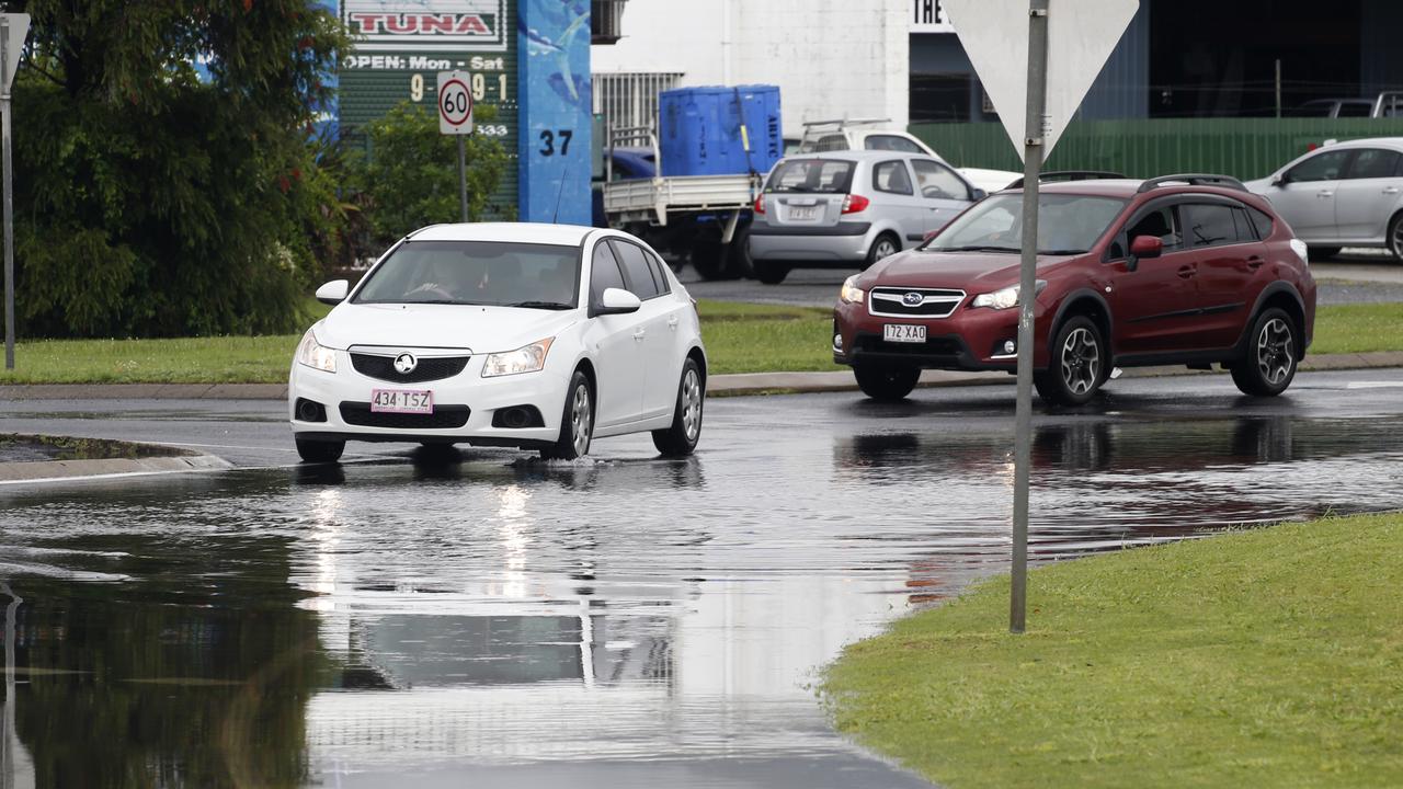 Cars try to avoid the water over the road during the high tide in Aumuller St PICTURE: ANNA ROGERS