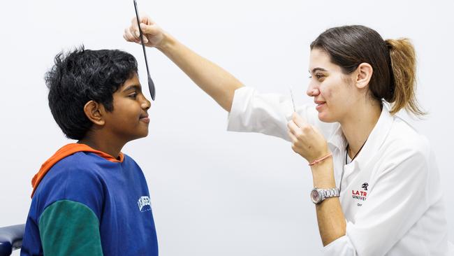 11-year-old Aiden Jose having his eyes examined by Christina Sovolos at the La Trobe University Eye Clinic. Photo: Aaron Francis