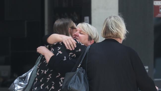 Family members of Mr Bohlsen embrace outside court. Picture: Annette Dew