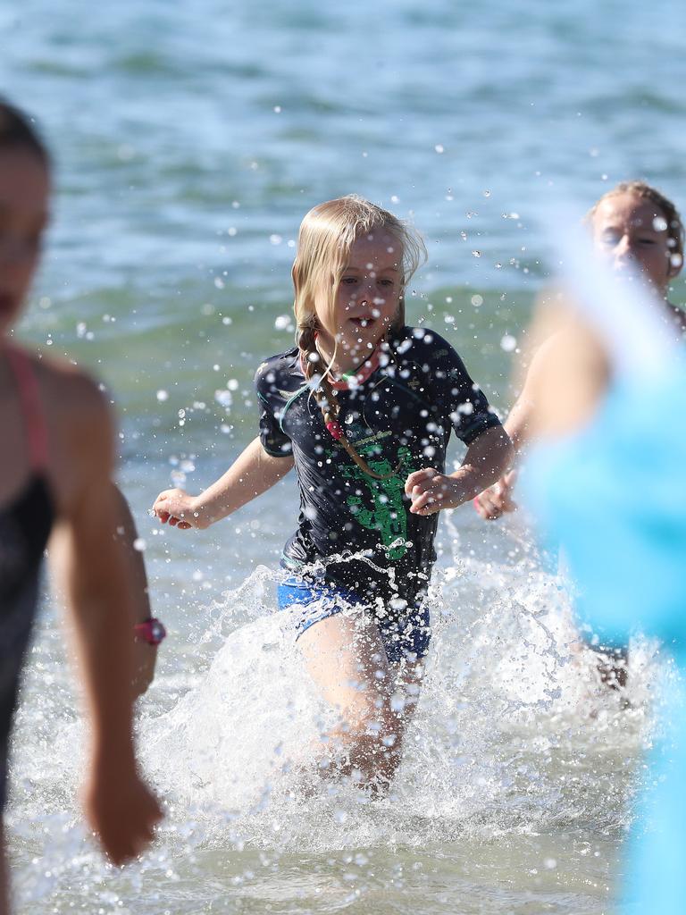 Participants in the 8 year old girls section finishing off their swim leg in the Bupa KidFit Series triathlon at Blackmans Bay Beach. Picture: LUKE BOWDEN