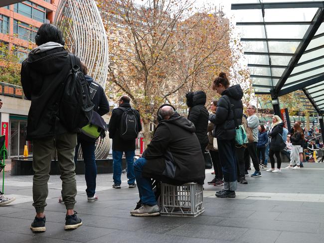 A long line of people queuing outside of the Sydney Passport Office. Picture: Justin Lloyd