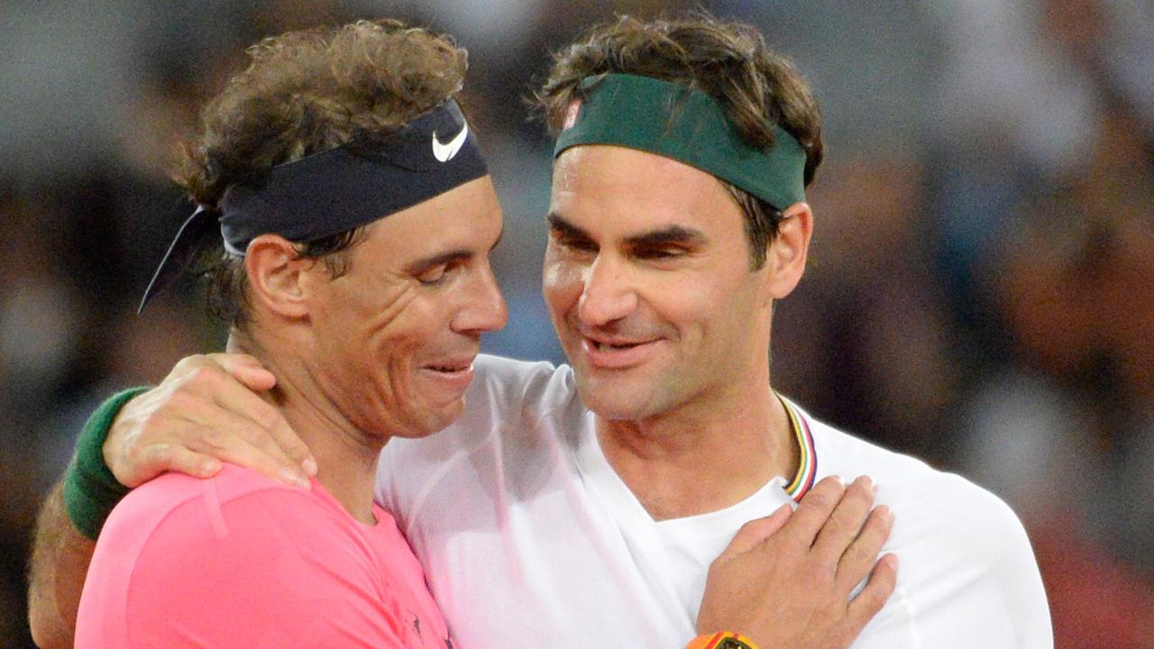 Switzerland's Roger Federer (R) hugs Spain's Rafael Nadal (L) during their tennis match at The Match in Africa at the Cape Town Stadium.