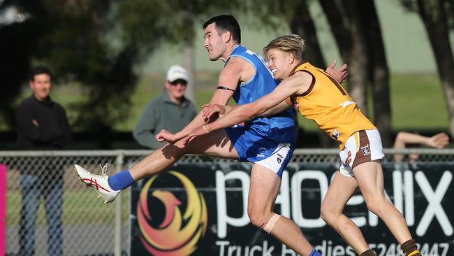 Barwon Heads forward Brock Close kicks under pressure from Luke Preece. Picture: Alan Barber