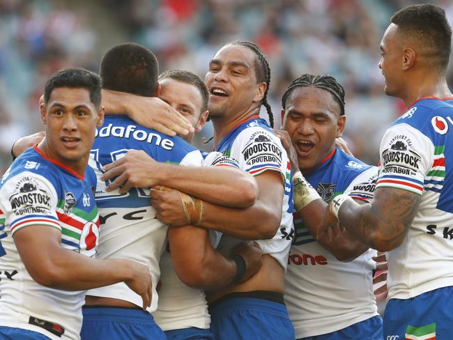 Leivaha Pulu celebrates with teammates after scoring a try.