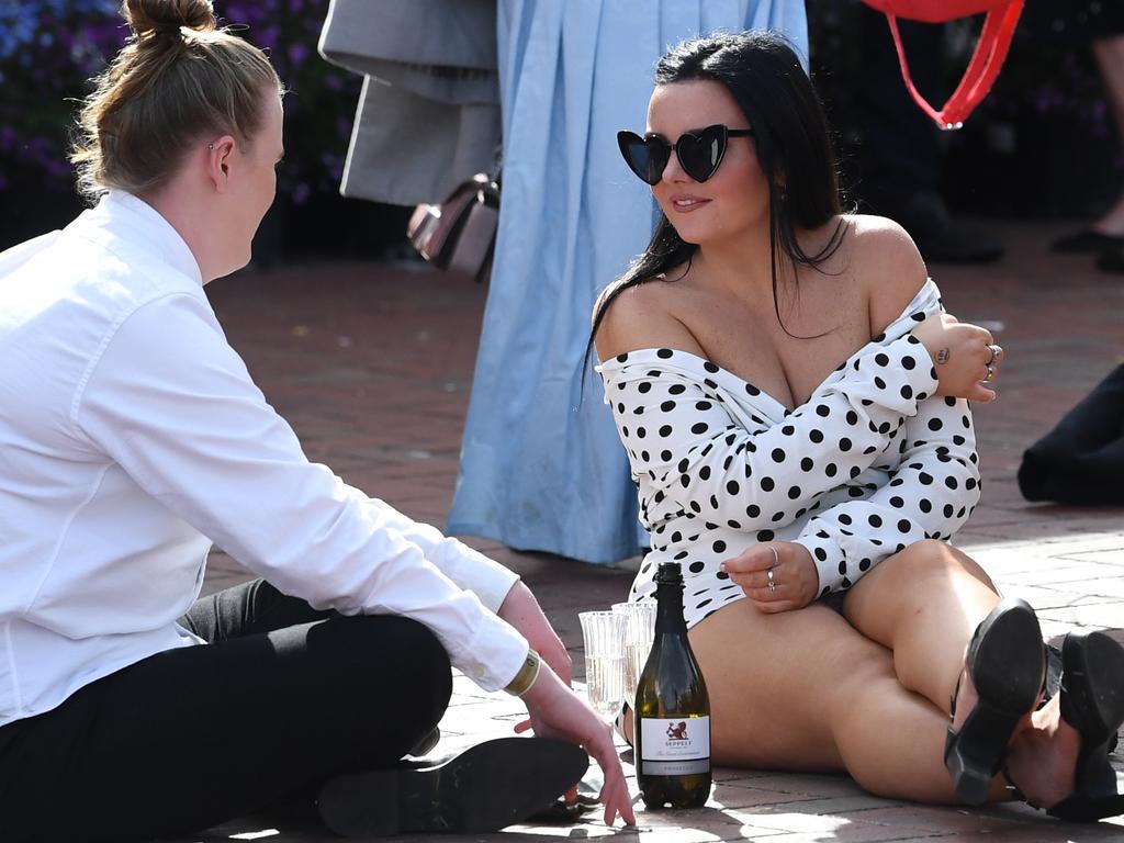 Who needs a picnic blanket when you can have wine on the floor? Picture: Julian Smith/AAP