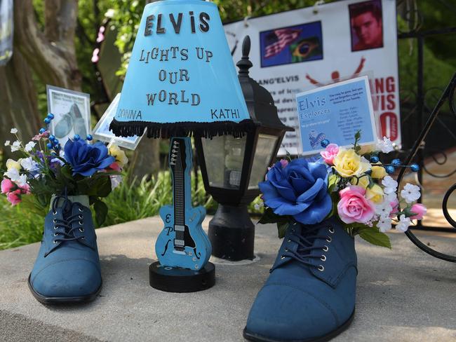 Other 40-year memorial tributes, including flower-filled blue suede shoes, for The King left in Graceland’s Meditation Garden where Elvis Presley is buried. Picture: AFP