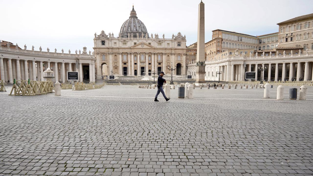 An Italian police officer walks in an empty St Peter’s Square in Rome after the Vatican erected a new barricade at the edge of the square. Picture: Andrew Medichini/AP