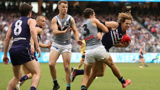 Nathan Fyfe of the Dockers looks to break from a tackle by Ryan Burton of the Power during the round 13 match at Optus Stadium. Picture: Getty Images