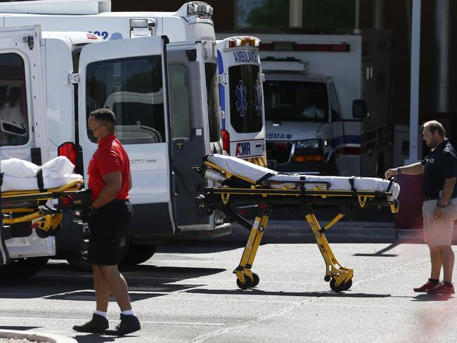 Medical transports and ambulances are parked outside an emergency room in Mesa, Arizona. Picture: AP