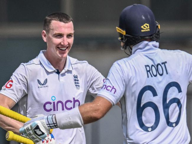 England's Harry Brook (L) celebrates with teammate Joe Root after scoring a double century (200 runs) during the fourth day of the first Test cricket match between Pakistan and England at the Multan Cricket Stadium in Multan on October 10, 2024. (Photo by Aamir QURESHI / AFP)