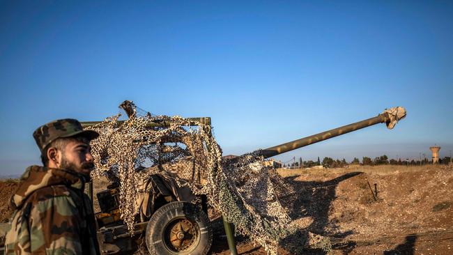 Fighters with the Kurdish-led Syrian Democratic Forces (SDF) inspect damaged and abandoned military vehicles and equipment at the Qamishli international airport, formerly a joint Syrian-russian military base, in northeastern Syria's city of Qamishli on December 9. Picture: AFP