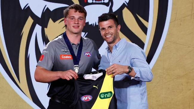 MELBOURNE, AUSTRALIA - NOVEMBER 20: The number one pick, Sam Lalor is presented his jumper by Trent Cotchin during the 2024 Telstra AFL Draft at Marvel Stadium on November 20, 2024 in Melbourne, Australia. (Photo by Michael Willson/AFL Photos via Getty Images)