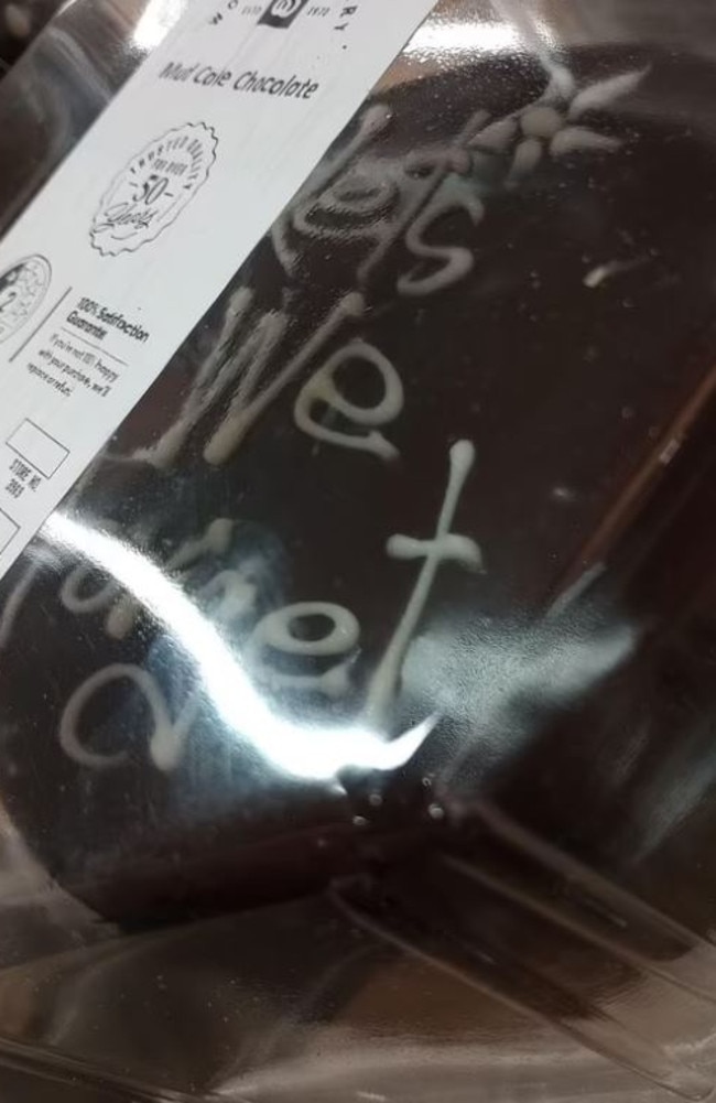 A shopper has gone viral on social media after sharing an image of an attempted Anzac Day tribute iced atop one of Woolworths’ beloved chocolate mudcakes. Picture: Reddit