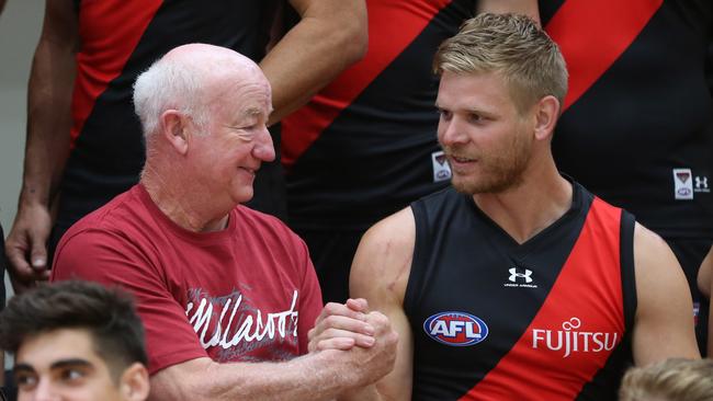 Michael Hurley greets a fan at Essendon’s Tullamarine base.