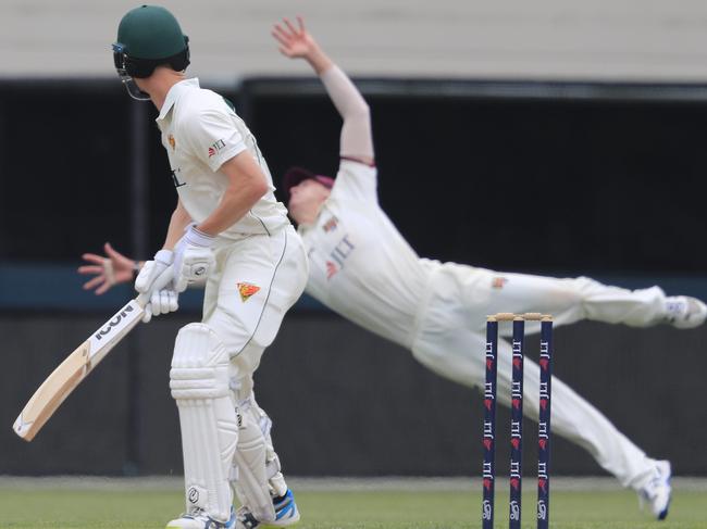 Saturday’s action from Day two: Matthew Renshaw of the Bulls (rear) dives for a catch from Jordan Silk of the Tigers during the Sheffield Shield match between Tasmania and Queensland at Blundstone Arena. Picture: AAP IMAGE/ROB BLAKERS