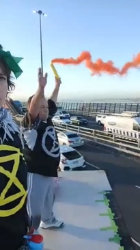 Climate protesters film themselves on truck on top of West Gate Bridge