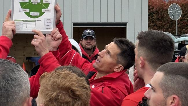 Ryan Webster addresses his Healesville players at quarter time.