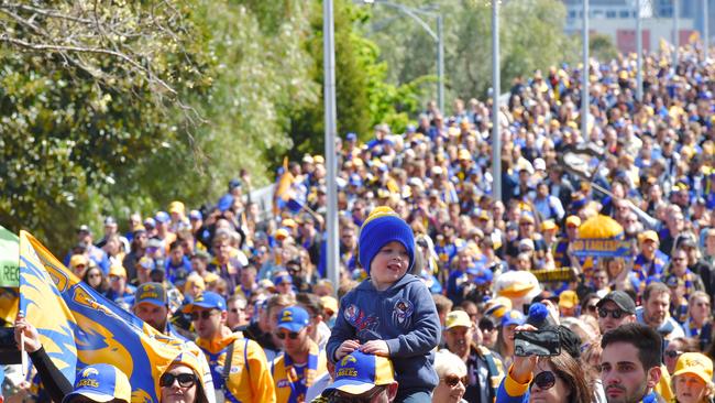 West Coast Eagles fans arrive at the MCG for the 2018 grand final. Merchandise sales following the club’s victory drove up profits. Picture: Jason Edwards