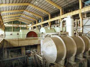 The giant, defunct coal-fired generator hall at Swanbank B. Its scale is demonstrated by a worker on the right. . Picture: David Nielsen