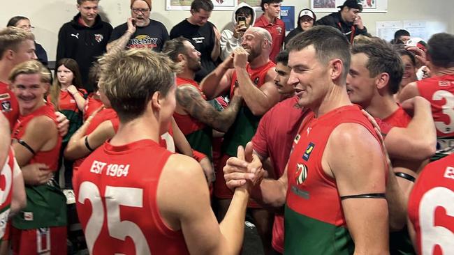 Lachlan Sharpe (No. 25) and Guy Hendry shake hands in the rooms after Pines' win on Saturday. Picture: Darcy Swayn