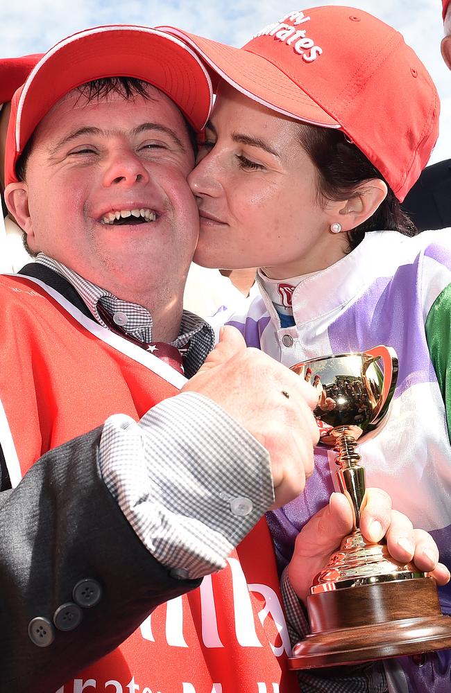 Steven Payne is all smiles as Michelle Payne lays a kiss on him.