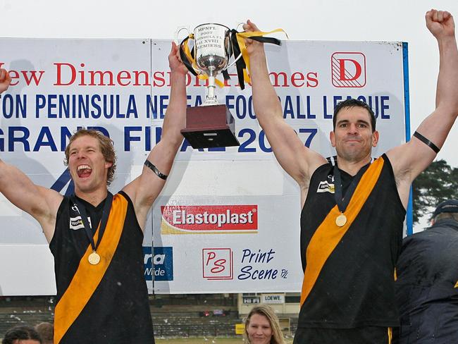 Seaford captain Scott Kemble (left) and playing-coach Paul Kennedy lift the 2007 MPNFL Peninsula premiership trophy.